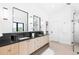Modern bathroom featuring double vanity, sleek mirrors, and walk-in shower with glass enclosure at 516 Grant Ave, Louisville, CO 80027