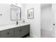Modern bathroom with a gray vanity, bathtub, and decorative art at 516 Grant Ave, Louisville, CO 80027