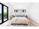 Contemporary bedroom featuring a large sliding glass door, accent windows, and stylish decor at 516 Grant Ave, Louisville, CO 80027