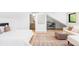 Well-lit bedroom featuring a sitting area, ensuite bathroom, and hardwood floors, offering style and functionality at 516 Grant Ave, Louisville, CO 80027