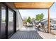Outdoor deck with overhead wood covering and comfortable seating for enjoying the scenic neighborhood views at 516 Grant Ave, Louisville, CO 80027