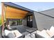 Relaxing outdoor deck with comfortable wicker seating, a coffee table, and a stylish overhead wood covering at 516 Grant Ave, Louisville, CO 80027