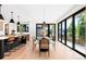 Elegant dining area with hardwood floors, modern lighting, and sliding glass doors to patio at 516 Grant Ave, Louisville, CO 80027