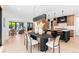 Open concept dining area with black table and modern decor connecting living room and kitchen at 516 Grant Ave, Louisville, CO 80027