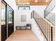 Bright entryway with hardwood floors, staircase, black iron railing, bench, and modern decor at 516 Grant Ave, Louisville, CO 80027