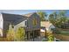 Modern home featuring a covered porch with a stone and dark gray siding at 516 Grant Ave, Louisville, CO 80027