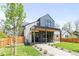 Stunning two-story home with modern design, grey shingles, white stone, and a covered porch at 516 Grant Ave, Louisville, CO 80027