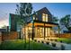Modern two-story home boasting sleek lines, dark accents, and a beautifully landscaped front yard at 516 Grant Ave, Louisville, CO 80027