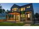 Exterior of the home at twilight, showcasing a patio, balcony, modern design, and lush green lawn at 516 Grant Ave, Louisville, CO 80027