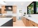 Modern kitchen featuring custom wood cabinetry, white countertops, and stainless steel appliances at 516 Grant Ave, Louisville, CO 80027