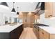 Well-lit kitchen boasts an expansive island, custom wood cabinets, stainless steel oven range, and bright countertops at 516 Grant Ave, Louisville, CO 80027