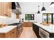 This open kitchen features modern wood cabinets, a large center island and stainless steel appliances at 516 Grant Ave, Louisville, CO 80027