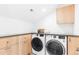 Well-organized laundry room featuring a front-load washer and dryer with stylish cabinetry and countertop at 516 Grant Ave, Louisville, CO 80027