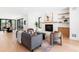 Cozy living room with a modern fireplace, hardwood floors, and large windows with backyard view at 516 Grant Ave, Louisville, CO 80027