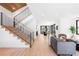 Bright and open living space with hardwood floors, staircase, and access to dining area at 516 Grant Ave, Louisville, CO 80027