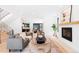 Open-concept living room with hardwood floors, modern fireplace, and views into dining and kitchen at 516 Grant Ave, Louisville, CO 80027