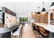 Bright open-concept living room with modern decor, hardwood floors, and natural light streaming in from large windows at 516 Grant Ave, Louisville, CO 80027