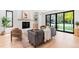 Sun-filled living room featuring a modern fireplace, hardwood floors, stylish furnishings, and large windows at 516 Grant Ave, Louisville, CO 80027
