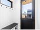 Mud room featuring a bench, coat hooks, a black door, and a view of the exterior at 516 Grant Ave, Louisville, CO 80027