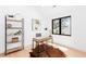 Bright home office with a desk, shelving, artwork, and natural light from a window overlooking the yard at 516 Grant Ave, Louisville, CO 80027