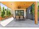 Covered patio with a wood ceiling, outdoor dining set and view of the backyard and surrounding landscape at 516 Grant Ave, Louisville, CO 80027