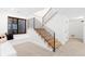 Bright staircase with wooden steps and black metal railing, adjacent to window seat at 516 Grant Ave, Louisville, CO 80027