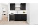 Modern wet bar features sleek black cabinetry, a wine fridge, and neutral countertops at 516 Grant Ave, Louisville, CO 80027