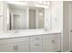 Bathroom with double sink vanity, bright lighting, and large mirror at 9089 Pitkin St, Commerce City, CO 80022