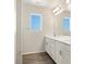 Bathroom with double sinks and a large window providing natural light at 9089 Pitkin St, Commerce City, CO 80022