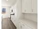 Contemporary kitchen featuring white cabinets, quartz countertops, stainless steel appliances, and wood floor at 9089 Pitkin St, Commerce City, CO 80022