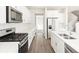 Modern kitchen with sleek white cabinets, stainless steel appliances, and a functional layout at 9089 Pitkin St, Commerce City, CO 80022