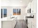 New kitchen featuring white cabinets, quartz countertops, stainless appliances, and tile backsplash at 9089 Pitkin St, Commerce City, CO 80022