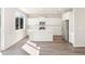 Bright, open kitchen featuring white cabinetry, stainless steel appliances, and a center island at 9089 Pitkin St, Commerce City, CO 80022