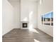 Bright living room with a modern fireplace, high ceilings, and lots of natural light at 9089 Pitkin St, Commerce City, CO 80022