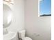 Bright powder room with modern fixtures including an oval mirror and sleek sink at 9089 Pitkin St, Commerce City, CO 80022
