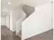 A naturally lit staircase with carpeted stairs and white banisters at 9089 Pitkin St, Commerce City, CO 80022