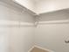 Spacious walk-in closet featuring ample hanging space with multiple rods and neutral carpet at 9089 Pitkin St, Commerce City, CO 80022