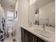 Bright bathroom with double vanity, white counter tops and a window at 10968 Pastel Pt, Parker, CO 80134