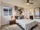 Bedroom with plush carpet, large picture window and access to the ensuite bathroom at 10968 Pastel Pt, Parker, CO 80134