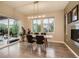Bright dining room with modern light fixture, fireplace, and sliding door to the outdoor deck at 10968 Pastel Pt, Parker, CO 80134