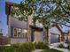 Side view of a two-story home featuring stone accents, gray siding, and well-maintained landscaping at 10968 Pastel Pt, Parker, CO 80134