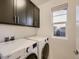 Modern laundry room with front-loading LG washer and dryer at 10968 Pastel Pt, Parker, CO 80134