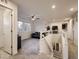 Bright living room with plush carpet, ceiling fan, and staircase at 10968 Pastel Pt, Parker, CO 80134
