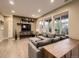 Spacious living room featuring modern decor, wood floors, and ample natural light from large windows at 10968 Pastel Pt, Parker, CO 80134