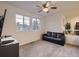 Comfortable living room featuring a black sofa and bright windows at 10968 Pastel Pt, Parker, CO 80134