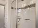 Modern shower with white tile surround and decorative mosaic tile at 10968 Pastel Pt, Parker, CO 80134