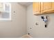 Laundry room features a window, wall cabinets, and washer/dryer hookups at 477 Saber Creek Dr, Monument, CO 80132