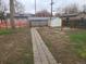 Spacious backyard includes a stone pathway and a storage shed, with plenty of space to enjoy at 4990 Hooker St, Denver, CO 80221