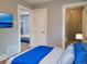 Cozy bedroom showcases modern decor and an ensuite bathroom with stylish tiled shower at 4990 Hooker St, Denver, CO 80221