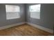 Bedroom features two windows for natural light and classic hardwood floors at 4990 Hooker St, Denver, CO 80221